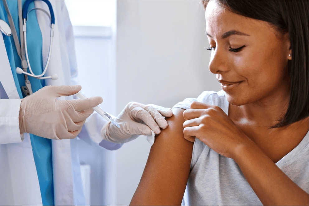 Doctor administering a flu vaccine to patient