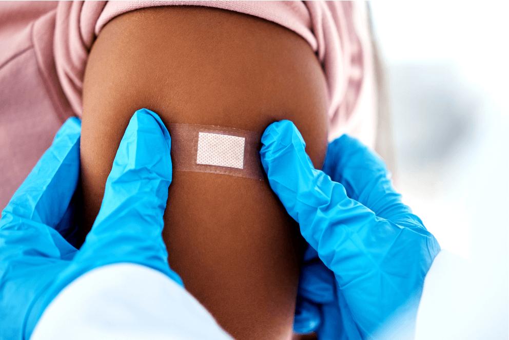 Doctor putting a bandage on a patient's arm