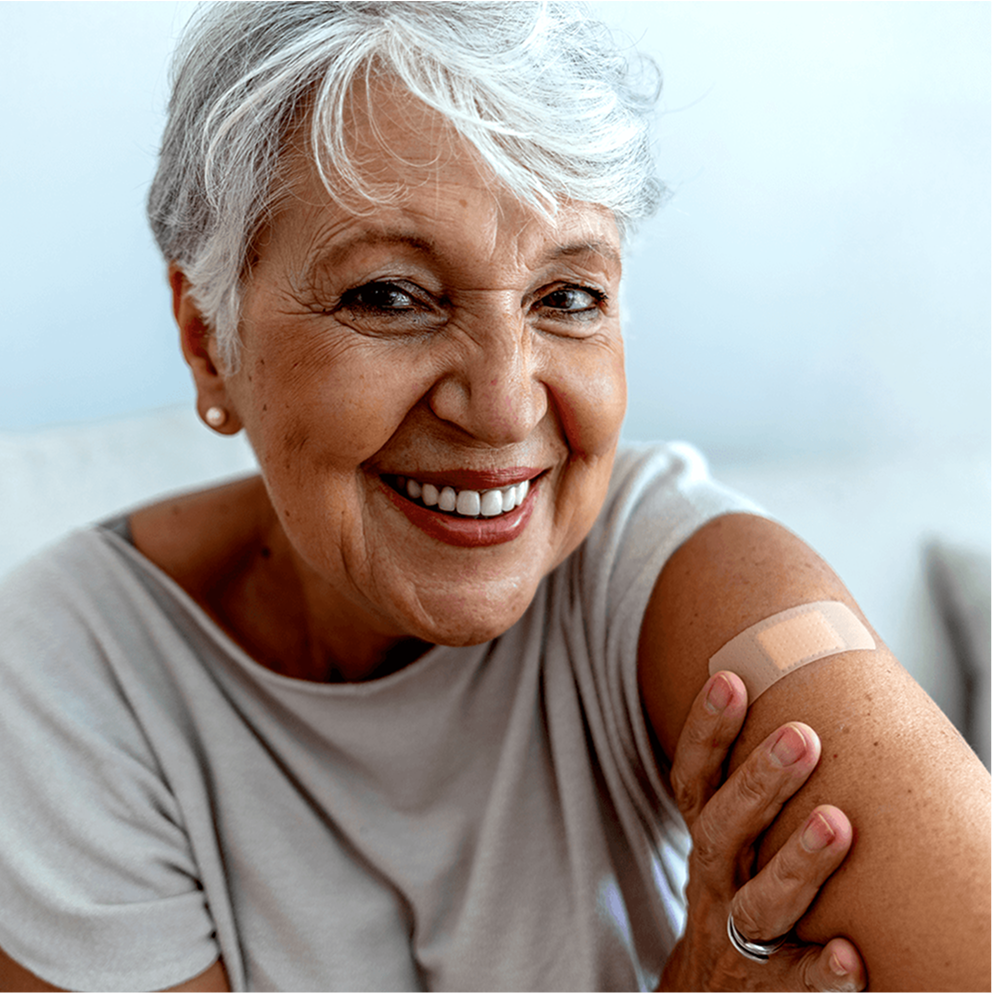 Patient smiling with bandage on their arm